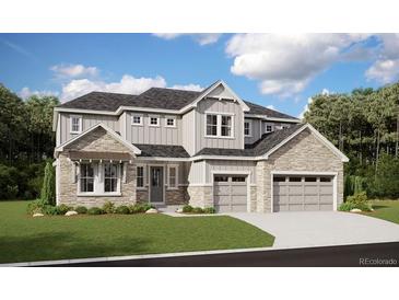 Two-story home featuring gray siding, stone accents, a three-car garage, and a well-manicured lawn at 4949 Hickory Oaks St, Castle Rock, CO 80104