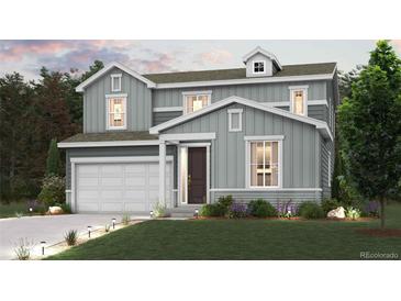 Two-story house with gray siding, attached garage, and landscaping at 1465 Bloom St, Brighton, CO 80601