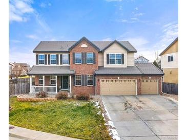 Two-story brick home with a three-car garage and landscaped yard at 7562 E 130Th Cir, Thornton, CO 80602