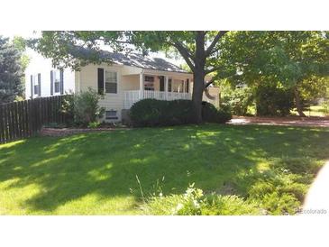 Charming single-story home with well-maintained front lawn and lovely landscaping provides great curb appeal at 6632 S Cedar St, Littleton, CO 80120