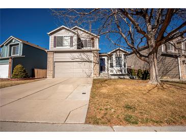 Charming two-story home with a two-car garage and a well-manicured front yard, perfect for Gathering living at 4927 Tarcoola Ln, Highlands Ranch, CO 80130