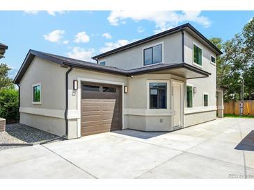 Inviting two-story home featuring a concrete driveway and an attached garage with automatic door at 3224 W Dakota Ave, Denver, CO 80219