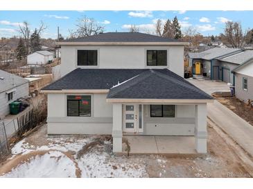 Two-story house with gray siding, dark roof, and small front porch at 3224 W Dakota Ave, Denver, CO 80219