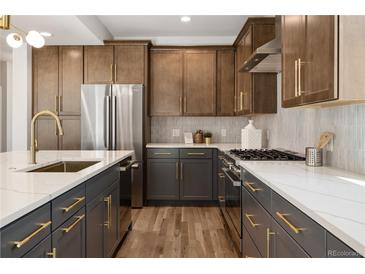 Contemporary kitchen with stainless steel appliances, custom cabinets, and quartz countertops at 2515 N Gaylord St, Denver, CO 80205