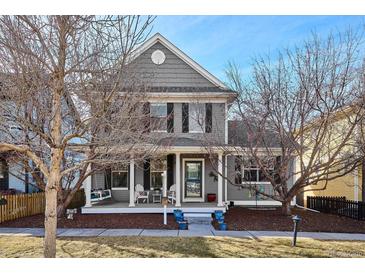 Charming two-story home with a welcoming front porch and landscaped yard at 2321 Alton St, Denver, CO 80238