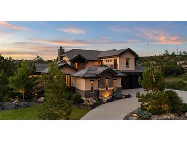 Beautiful two-story home with stone accents, manicured landscaping, and a private balcony at 1803 Avenida Del Sol, Castle Rock, CO 80104