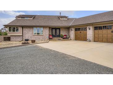 Charming brick home with a well-manicured front yard and a double-door entry and brick driveway at 3191 W 151St Ct, Broomfield, CO 80023