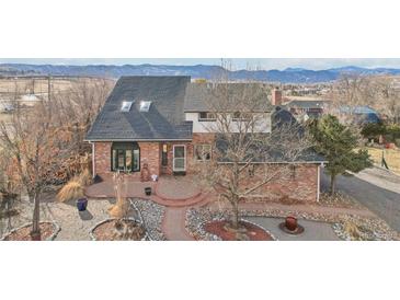 Classic brick two-story residence featuring a landscaped garden and beautiful brick walkway at 767 Ellis St, Golden, CO 80401