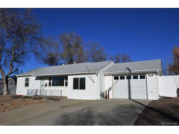 Charming one-story home featuring a clean, white exterior with a well-maintained front yard and attached garage at 5142 S Pennsylvania St, Littleton, CO 80121