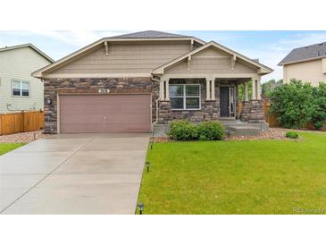 Charming single-Gathering home featuring stone accents, a well-manicured lawn, and a two-car garage at 3838 Brush Rd, Castle Rock, CO 80108