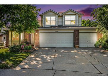 Charming two-story home featuring a three car garage and well-maintained landscaping at 1010 Home Farm Cir, Denver, CO 80234