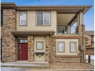 Attractive two-story condo featuring a red door, stone accents, and a balcony on the second floor at 11391 Navajo Cir # B, Westminster, CO 80234
