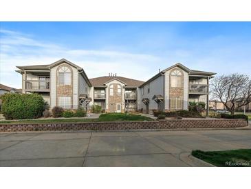 Attractive multi-Gathering home featuring a stone facade, balconies, and well-maintained landscaping at 10381 Cook Way # 202, Thornton, CO 80229