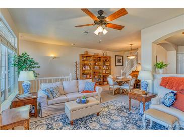 Inviting living room features a ceiling fan, and an elegant area rug at 494 Black Feather Loop # 117, Castle Rock, CO 80104