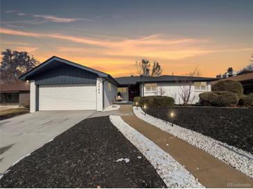 Charming home with an attached garage and beautifully landscaped front yard, perfect for curb appeal at 6585 E Nevada Pl, Denver, CO 80224