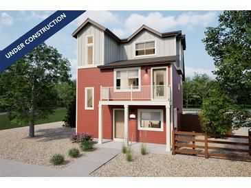 New construction two-story home featuring a balcony, gravel landscaping, and a charming exterior design at 13563 E 103Rd Pl, Commerce City, CO 80022