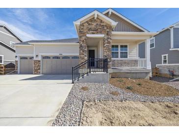 Charming home with stone accents, covered porch, manicured landscaping and a two car garage at 4066 N Irvington St, Aurora, CO 80019