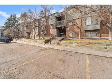 Brick building exterior with parking and landscaping at 3656 S Depew St # 104, Denver, CO 80235