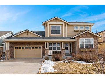 Charming two-story home featuring stone accents, a two-car garage, and a welcoming front porch at 258 N Catawba Ct, Aurora, CO 80018