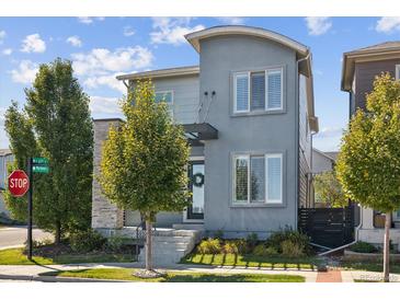 Contemporary home with a stone accent, well-manicured lawn, and inviting front entrance at 6777 Mariposa St, Denver, CO 80221