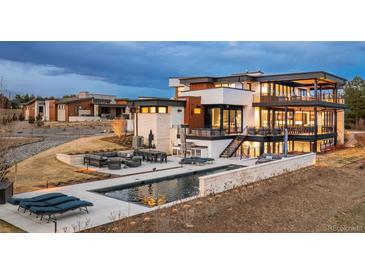 Expansive modern home with outdoor kitchen, pool and dining areas that offers a luxurious outdoor entertaining at 5140 S Kearney Ct, Greenwood Village, CO 80111