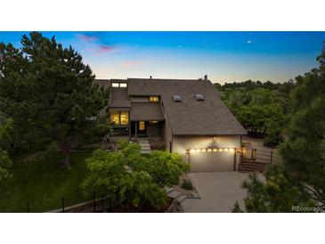 Beautiful two-story home with a well-manicured lawn, lush landscaping, and an attached two-car garage at 5812 Irish Pat Murphy Dr, Parker, CO 80134