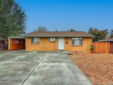 Charming single story home with a brick facade and a large concrete driveway at 3771 S Federal Blvd, Englewood, CO 80110