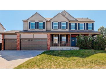 Charming two-story home featuring a welcoming front porch and a spacious three-car garage at 11680 Crow Hill Dr, Parker, CO 80134