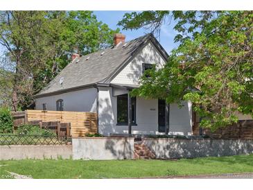 Charming home with a well-maintained yard, mature trees, and inviting front exterior at 3817 Osage St, Denver, CO 80211