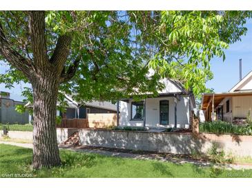 Charming home with a well-maintained front yard and inviting curb appeal, including mature tree coverage at 3817 Osage St, Denver, CO 80211