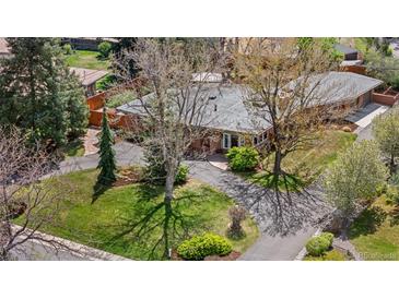Aerial view of ranch-style home featuring mature landscaping, a circular driveway, and a well-maintained yard at 5471 S Sherman St, Littleton, CO 80121