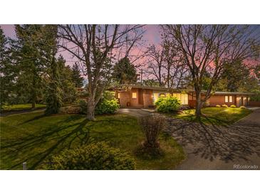 Charming brick ranch-style home with a well-manicured lawn and mature trees, offering great curb appeal at 5471 S Sherman St, Littleton, CO 80121