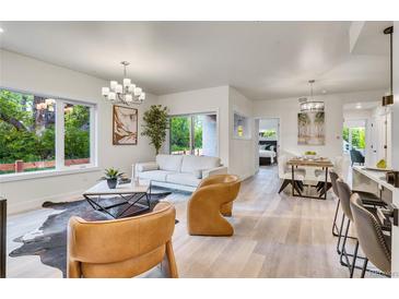 Bright living room with modern furnishings, hardwood floors, and lots of natural light from large window at 1308 Snowberry Ln # 304, Louisville, CO 80027