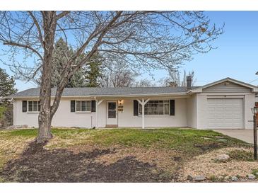 Charming white brick home with a well-maintained lawn and attached two-car garage at 3693 E Costilla Ave, Centennial, CO 80122