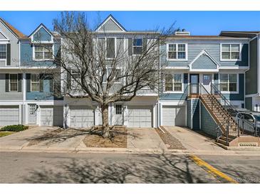 Charming townhome with eye-catching curb appeal, private garages, and inviting entryways at 1699 S Trenton St # 147, Denver, CO 80231