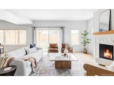 Bright living room with a modern fireplace, stylish furniture, and hardwood floors at 108 Arapahoe St, Golden, CO 80403