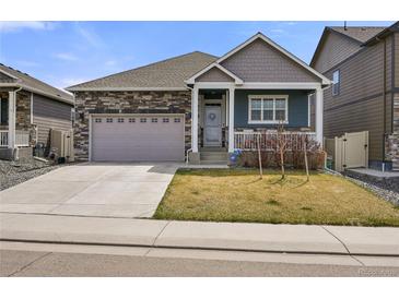 Charming single-Gathering home featuring stone accents, a two-car garage, and a welcoming front porch at 6912 Poudre St, Frederick, CO 80530