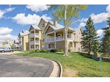 Inviting multi-story condo with a private porch, landscaped lawn and sidewalks at 6013 Castlegate W Dr # D14, Castle Rock, CO 80108