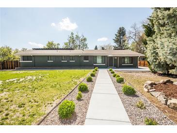 Charming one-story home with green brick, manicured lawn, and walkway to the entrance at 863 S Dudley St, Lakewood, CO 80226