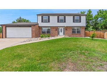 Charming two-story home with a well-manicured lawn and inviting curb appeal at 9451 W Hialeah Pl, Littleton, CO 80123