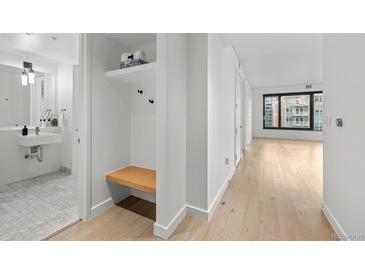 Modern bathroom featuring a stylish vanity and a convenient built-in bench and storage area at 1750 Wewatta St # 1227, Denver, CO 80202