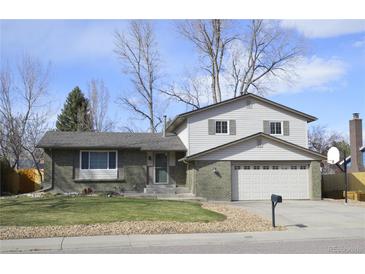 Charming two-story home with a well-maintained front yard and attached two-car garage at 12173 W 68Th Ave, Arvada, CO 80004