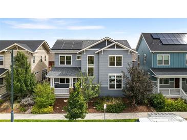 Two-story craftsman style home with solar panels and landscaped yard at 5524 Uinta St, Denver, CO 80238