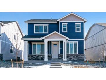 Two-story blue home with gray accents and a stone base at 693 N Tempe St, Aurora, CO 80018