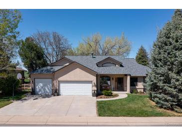 Charming single-Gathering home featuring a well-manicured lawn, mature trees, and a spacious two-car garage at 2539 Lake Meadow Dr, Lafayette, CO 80026
