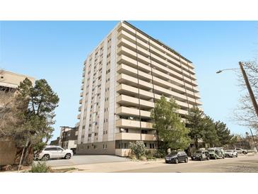 High-rise apartment building with multiple balconies and surrounding trees at 1029 E 8Th Ave # 901, Denver, CO 80218