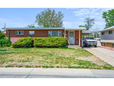 Charming single-story brick home with a covered parking area and well-maintained front yard at 245 S 13Th Ave, Brighton, CO 80601