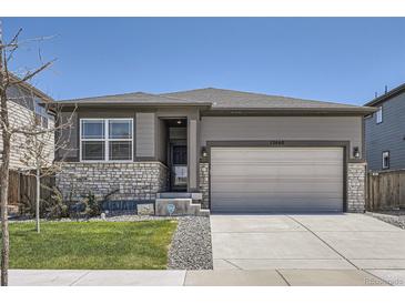Charming single-Gathering home featuring a two-car garage, manicured lawn, and inviting front entrance at 13460 Broad Wing Ave, Parker, CO 80134