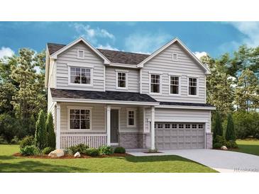 Charming two-story home with neutral siding, manicured lawn, and attached two-car garage in a serene community at 661 Split Rock Dr, Erie, CO 80516