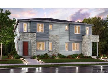 Beautiful modern home with stone accents, a red front door, and manicured landscaping at 14109 Deertrack Ln, Parker, CO 80134